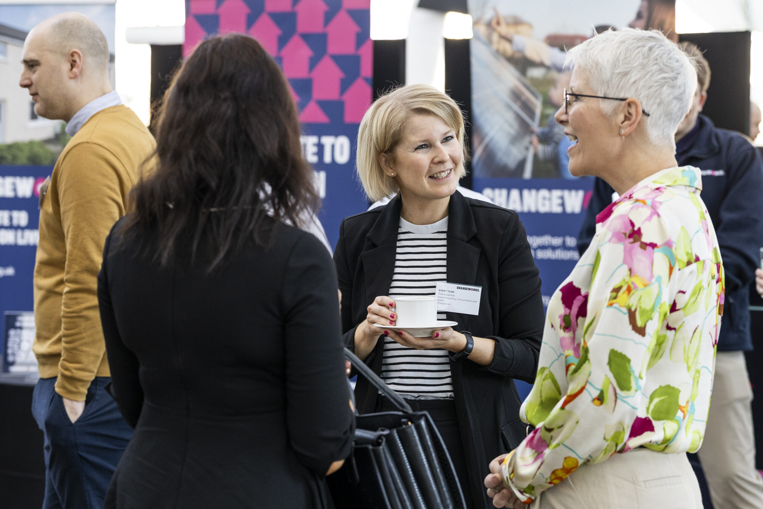 Individuals chatting in group of three at Changeworks event