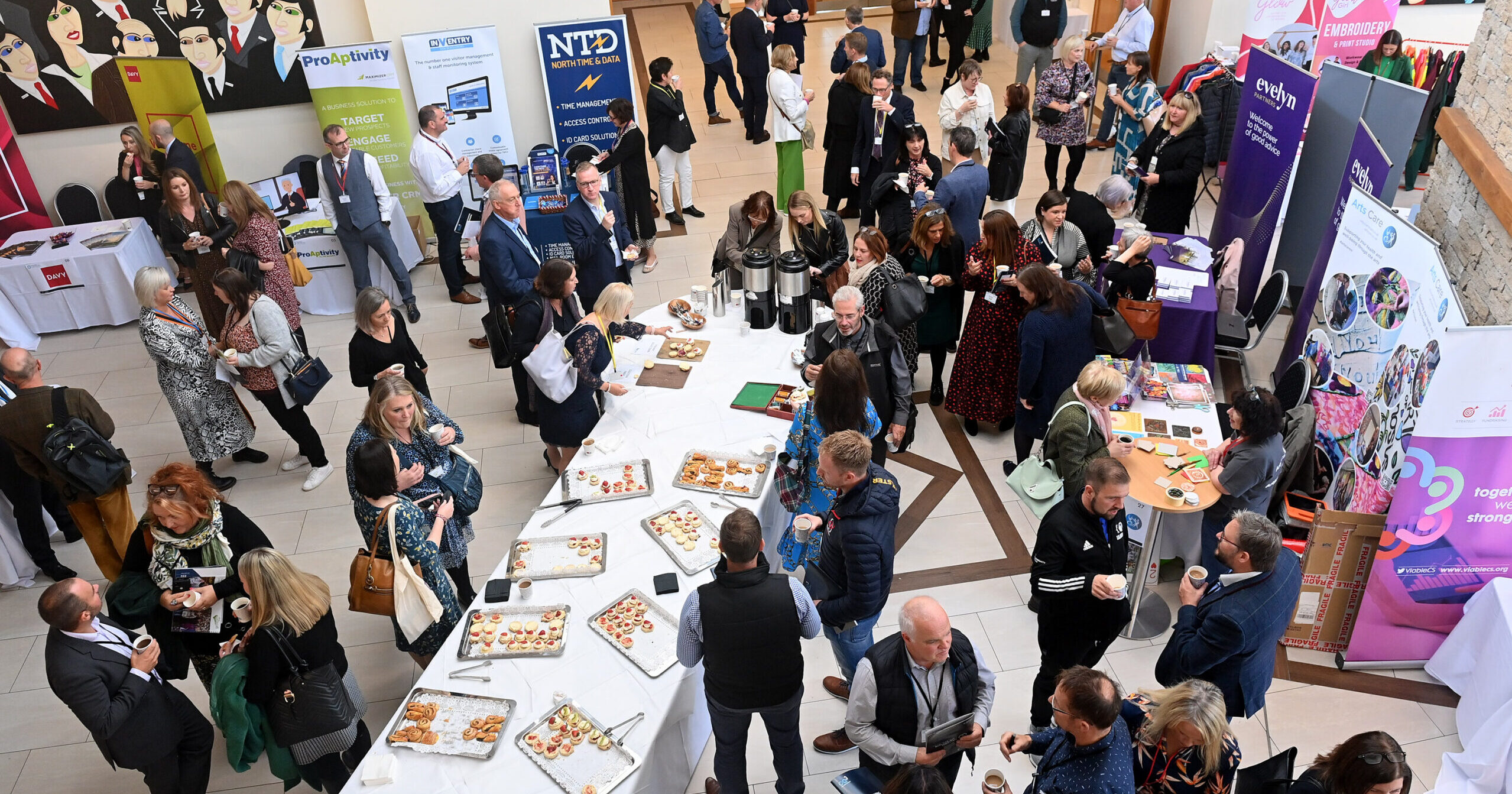 Participants talking and mingling in a large room photographed from above